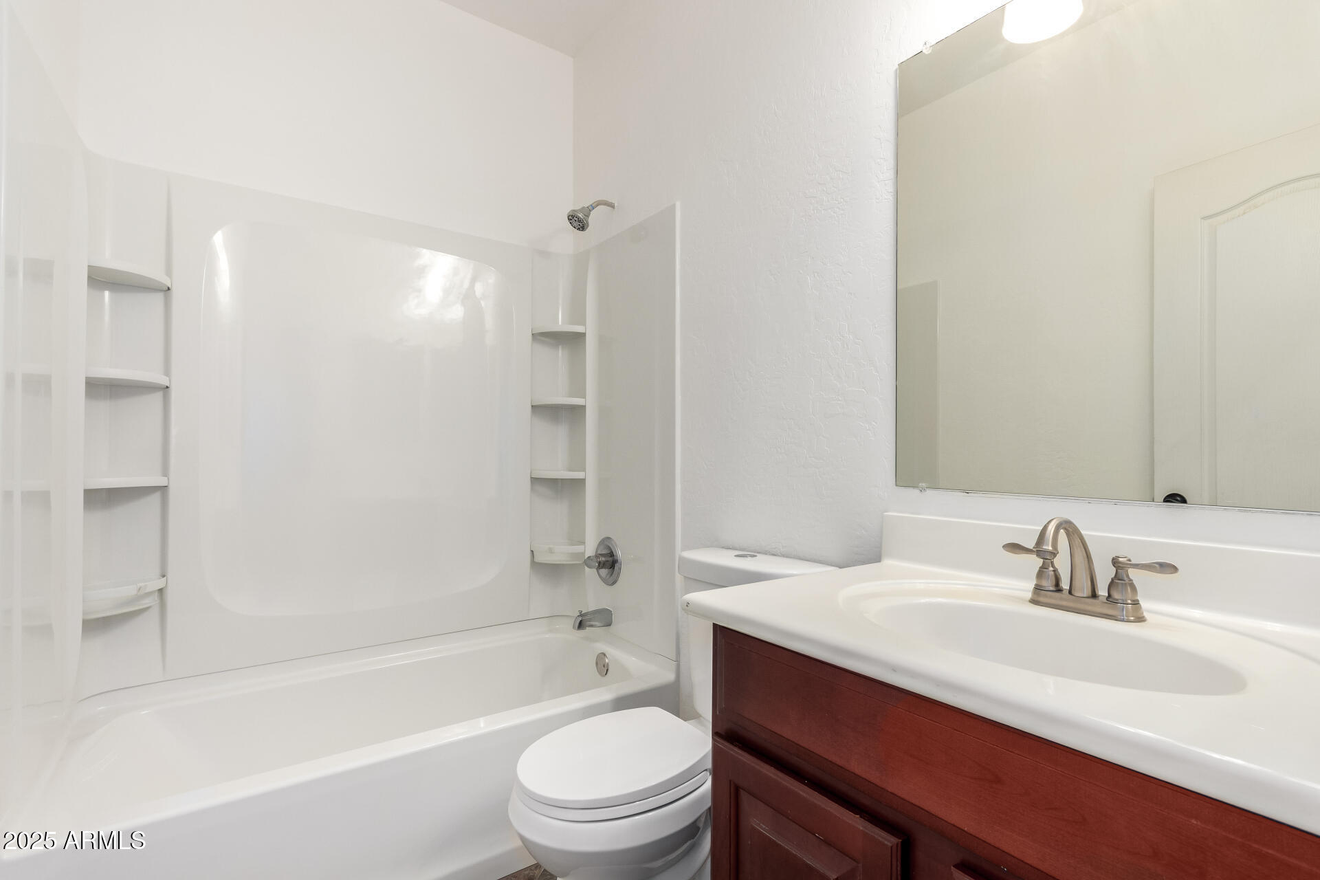 1126 East Pedro Road Phoenix, AZ 85042 - Photo 22 of 34 a bathroom with a bathtub shower sink vanity mirror and toilet