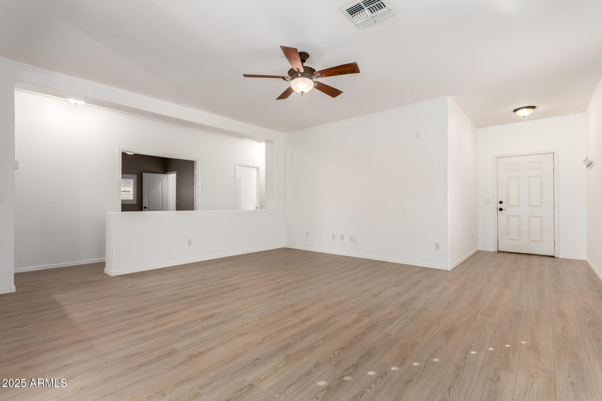 1126 East Pedro Road Phoenix, AZ 85042 - Photo 3 of 34 wooden floor in an empty room with a window