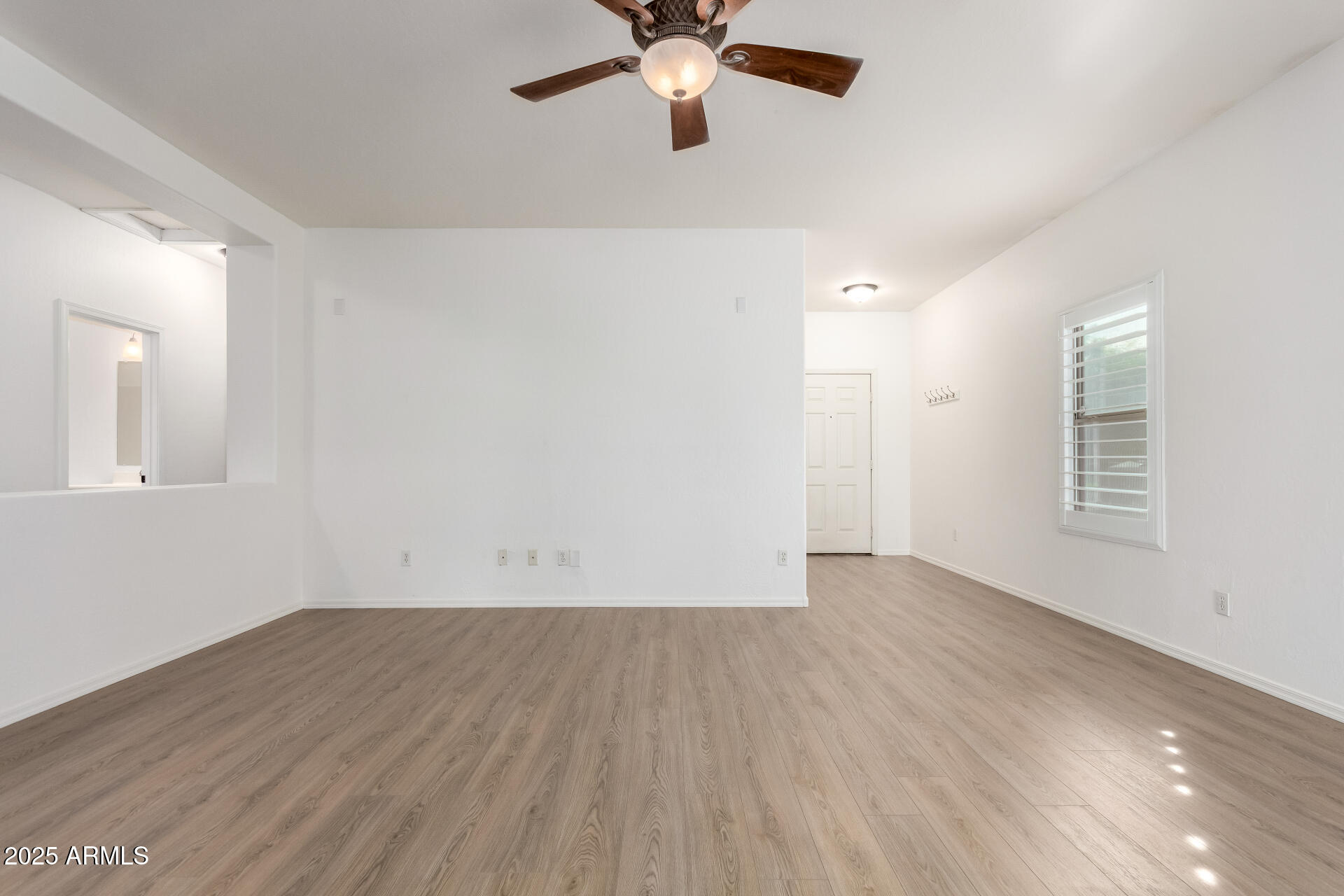 1126 East Pedro Road Phoenix, AZ 85042 - Photo 6 of 34 wooden floor in an empty room with a window
