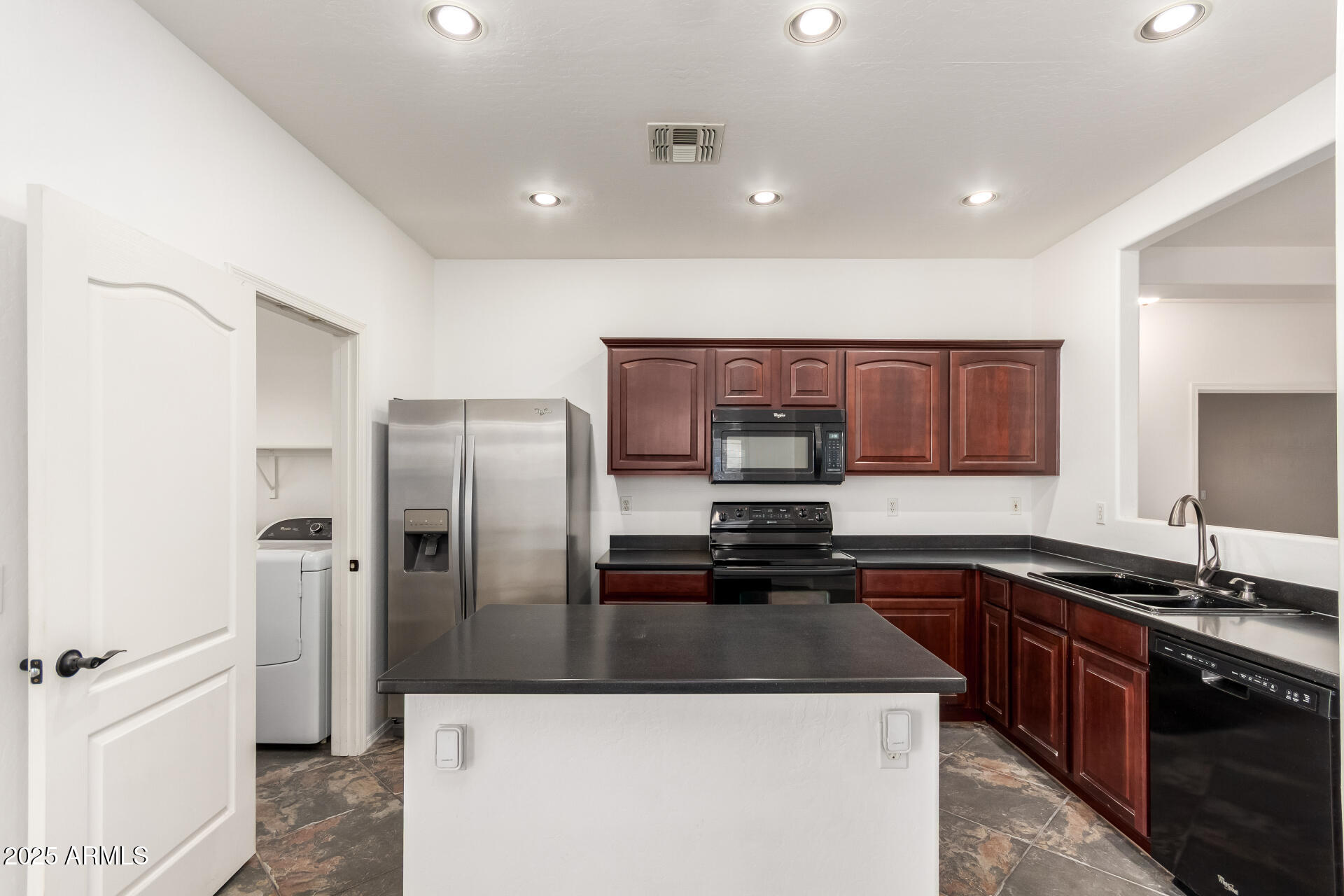 1126 East Pedro Road Phoenix, AZ 85042 - Photo 7 of 34 a kitchen with stainless steel appliances granite countertop a sink a stove and a refrigerator