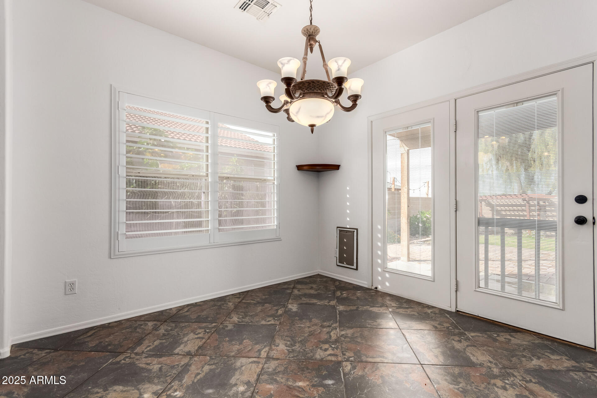 1126 East Pedro Road Phoenix, AZ 85042 - Photo 10 of 34 a view of an empty room with a window