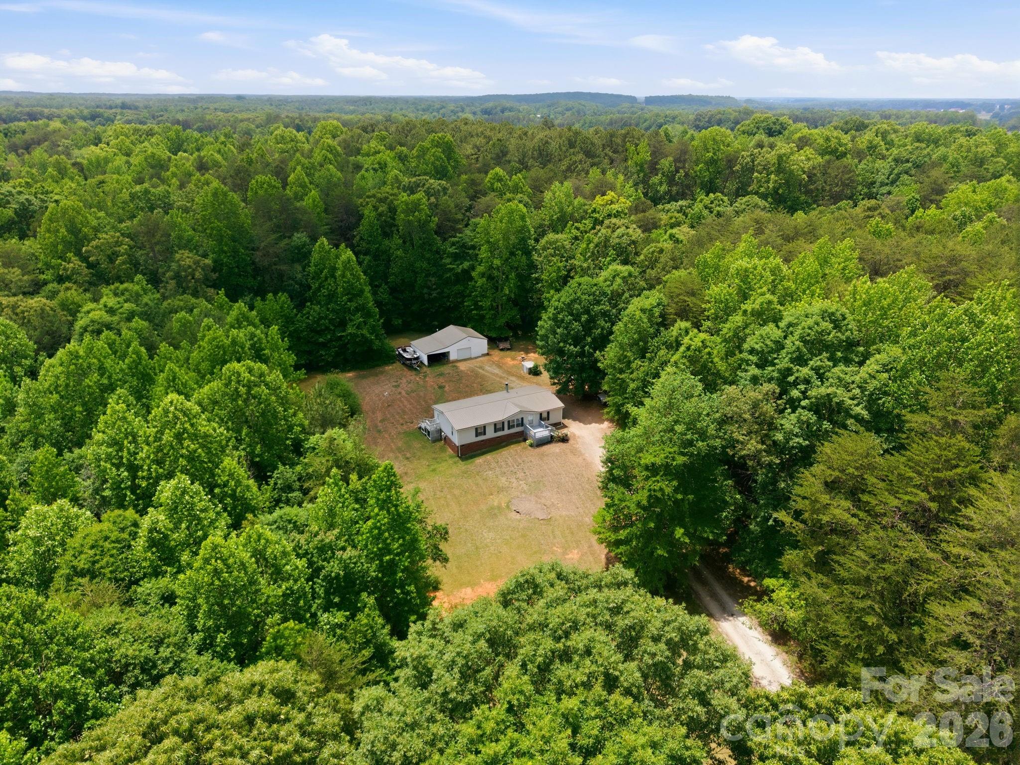 675 Overcash Road Salisbury, NC 28147 - Photo 43 of 48 a view of a garden with a building in the background
