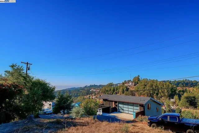 a view of a house with a yard and balcony