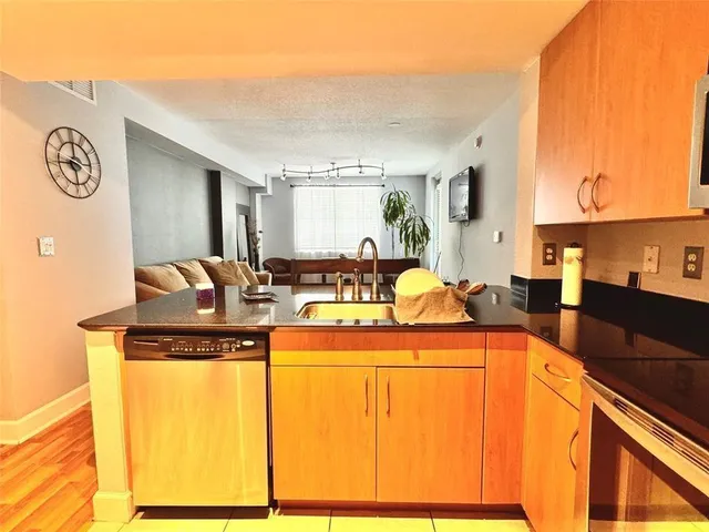 a view of a kitchen with a sink and a refrigerator