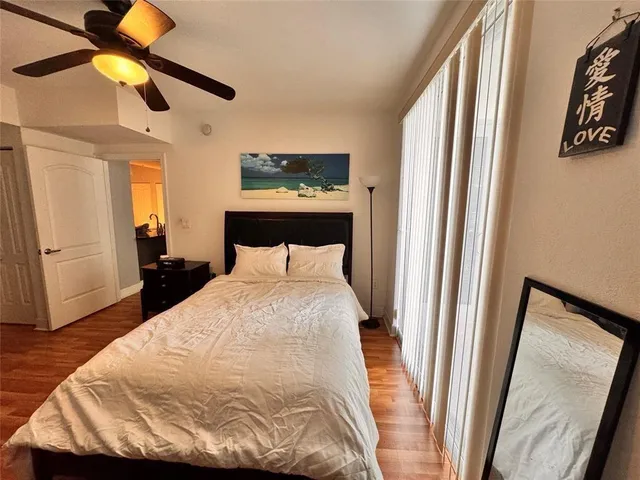 a bedroom with a bed and a mirror