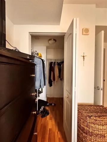 a view of walk in closet with clothes and shoes