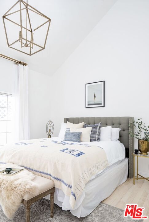138 Roma Court Marina del Rey, CA 90292 - Photo 31 of 38 a bedroom with a bed and a chandelier