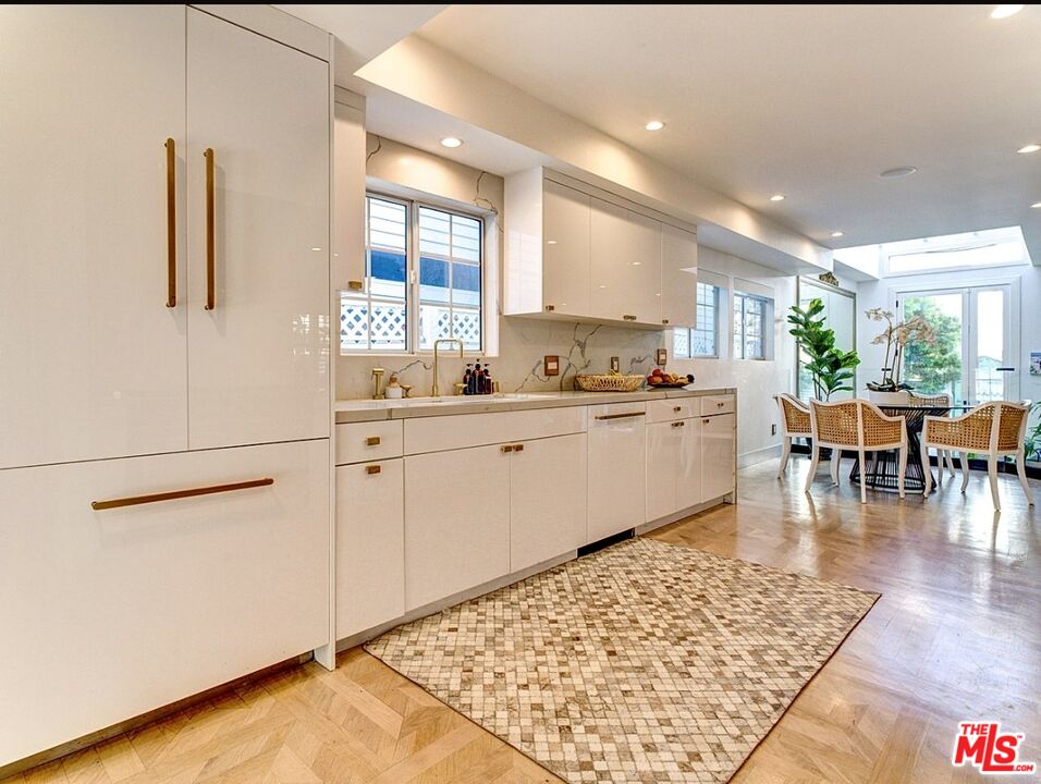 138 Roma Court Marina del Rey, CA 90292 - Photo 9 of 38 a kitchen with a sink and chairs