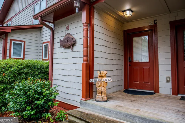 a view of a balcony with chair and wooden floor