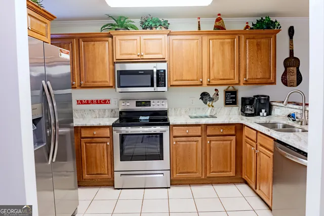 a living room with furniture a flat screen tv and kitchen view