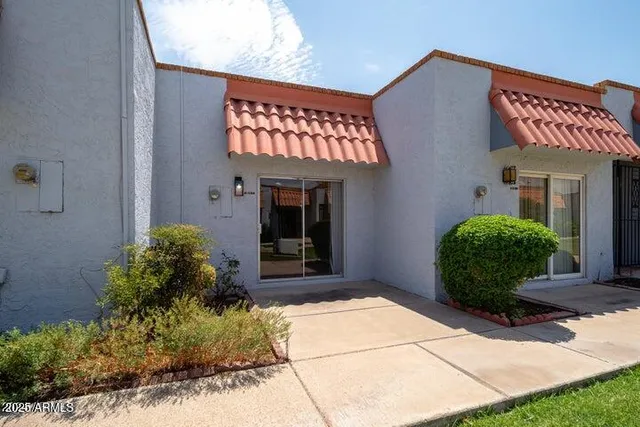 a view of a house with a small yard and plants