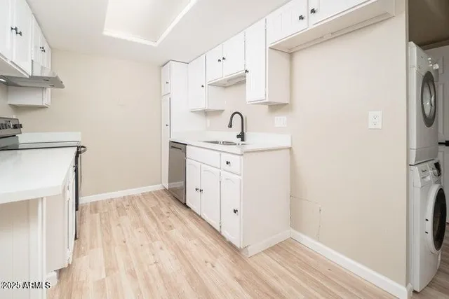 a kitchen with white cabinets and white appliances