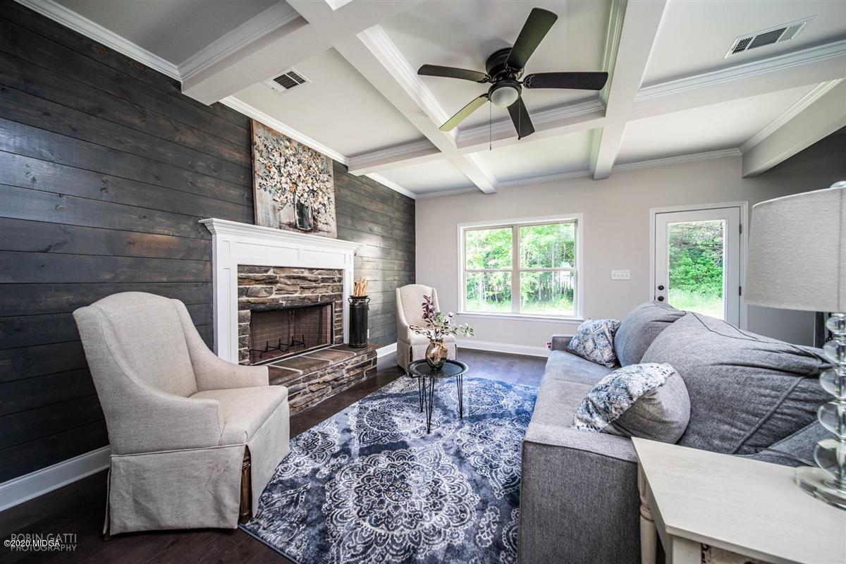339 Walnut Grove Road Gray, GA 31032 - Photo 11 of 30 a living room with furniture a fireplace and a flat screen tv
