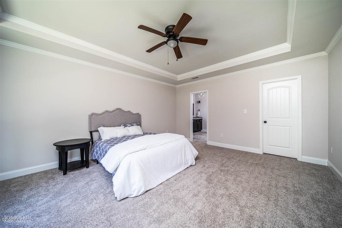 339 Walnut Grove Road Gray, GA 31032 - Photo 15 of 30 a spacious bedroom with a bed and ceiling fan