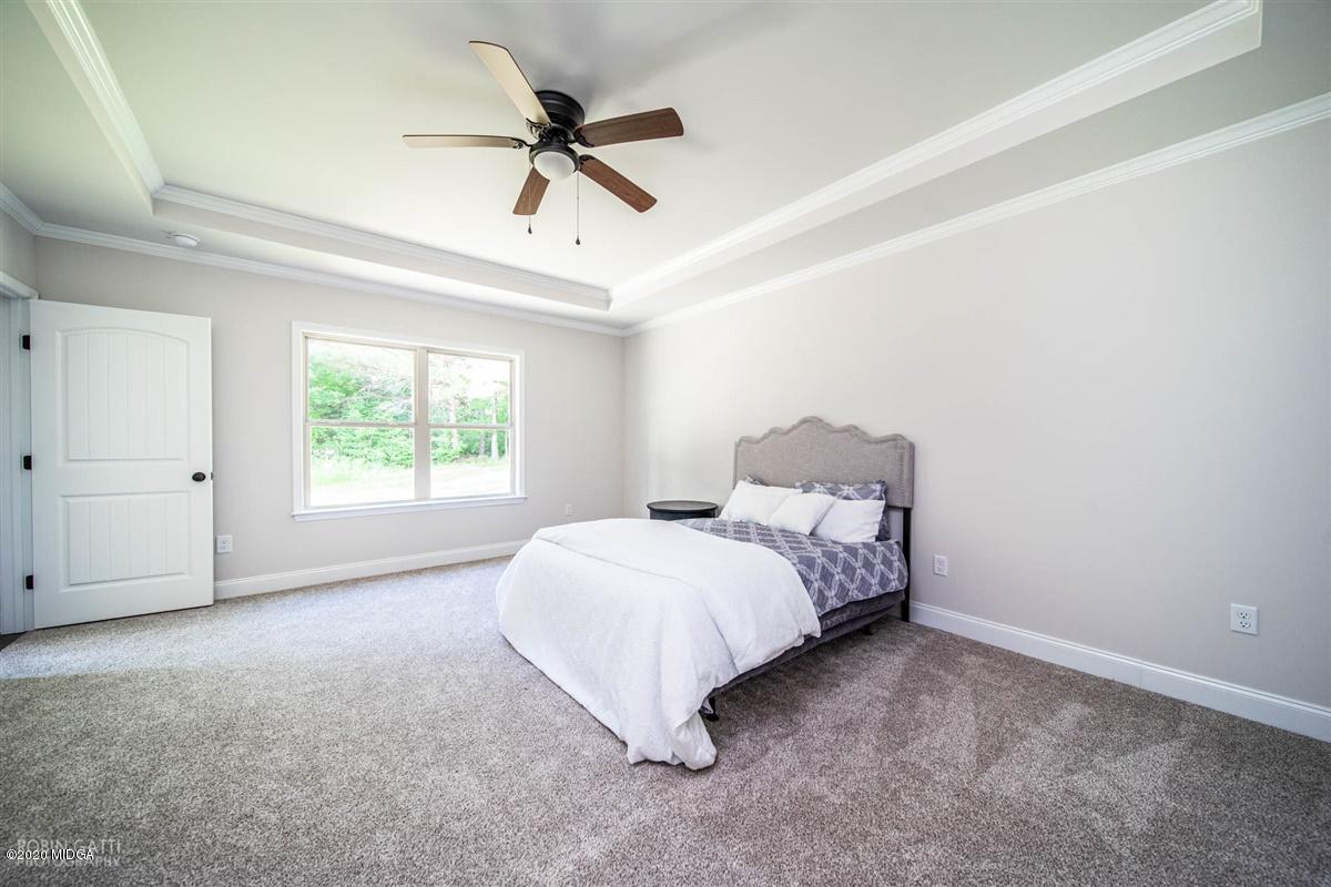 339 Walnut Grove Road Gray, GA 31032 - Photo 16 of 30 a bed room with a bed and a ceiling fan