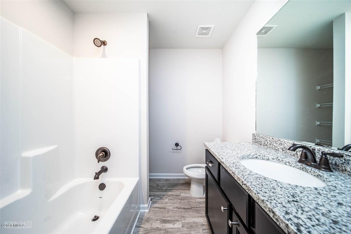 339 Walnut Grove Road Gray, GA 31032 - Photo 20 of 30 a bathroom with a granite countertop tub sink and mirror