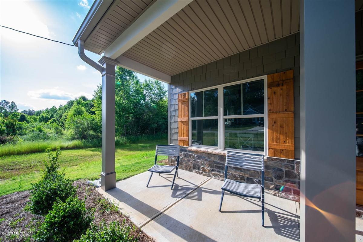 339 Walnut Grove Road Gray, GA 31032 - Photo 3 of 30 a view of a patio with a table chairs and a yard
