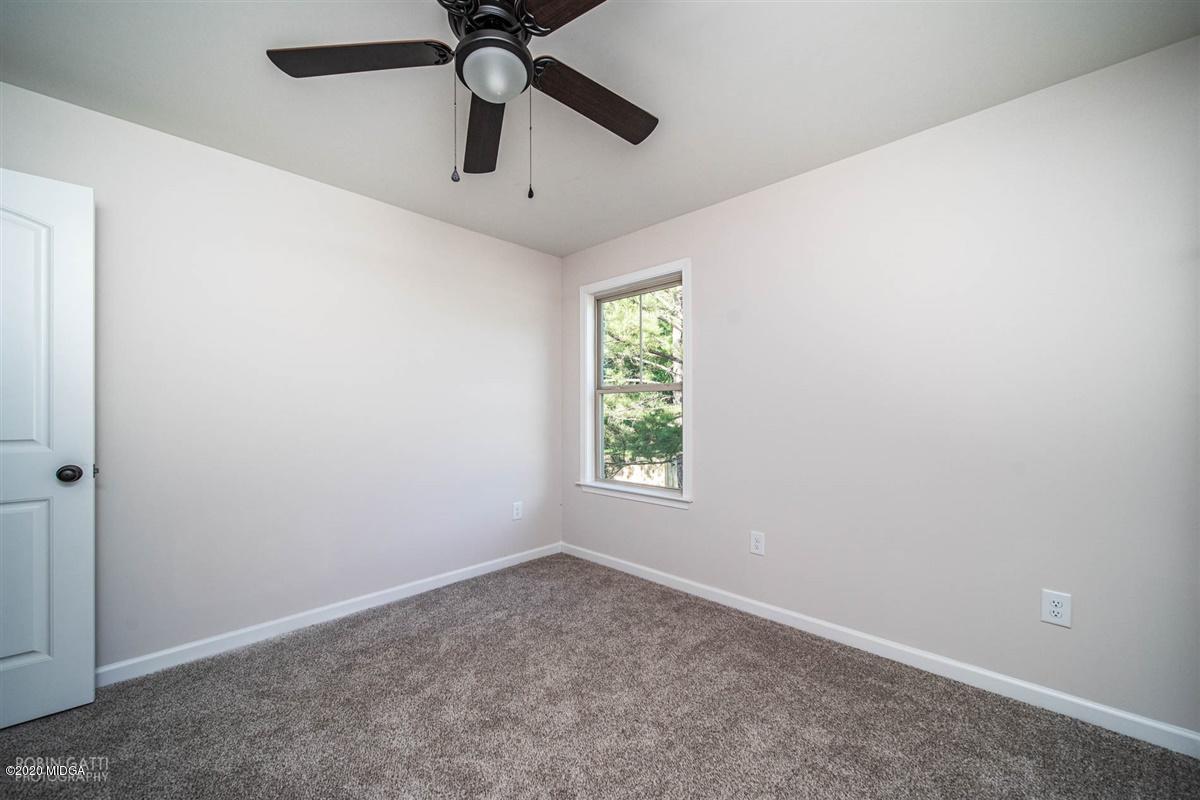 339 Walnut Grove Road Gray, GA 31032 - Photo 22 of 30 an empty room with a window and a fan