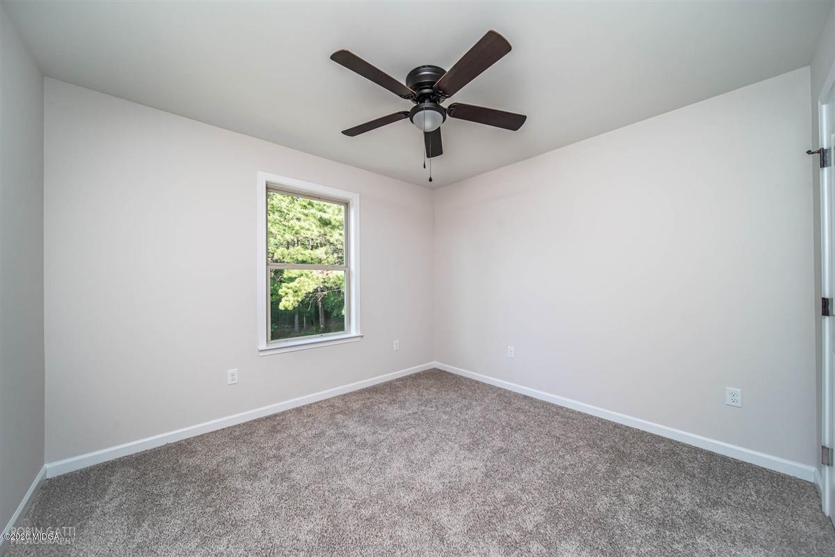 339 Walnut Grove Road Gray, GA 31032 - Photo 24 of 30 an empty room with ceiling fan and window