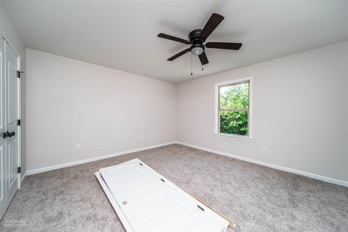 339 Walnut Grove Road Gray, GA 31032 - Photo 29 of 30 an empty room with a window and a ceiling fan