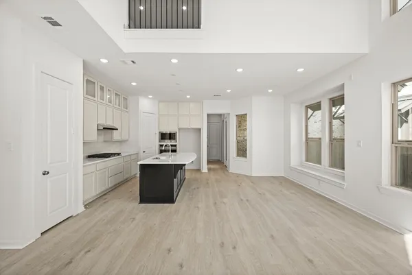 a large kitchen with a lot of counter space and stainless steel appliances