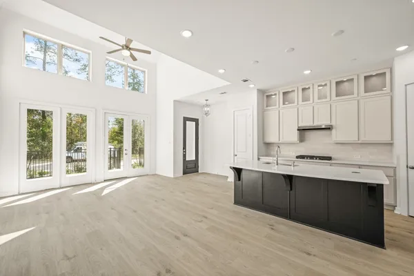 a large kitchen with stainless steel appliances granite countertop a stove and a sink