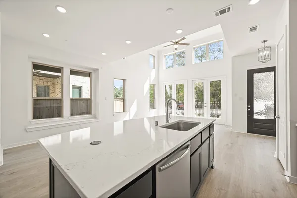 a kitchen with granite countertop a sink and chandelier