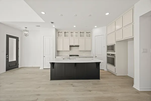 a view of kitchen with stainless steel appliances granite countertop a stove and a refrigerator