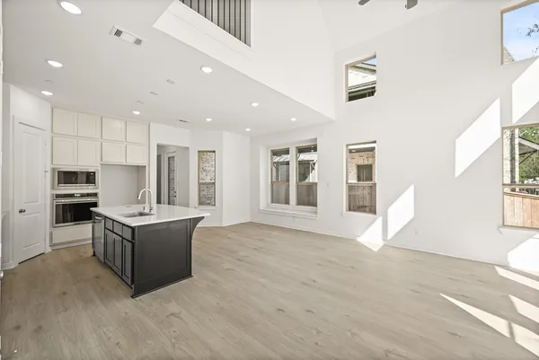 a living room with kitchen island furniture and a kitchen view