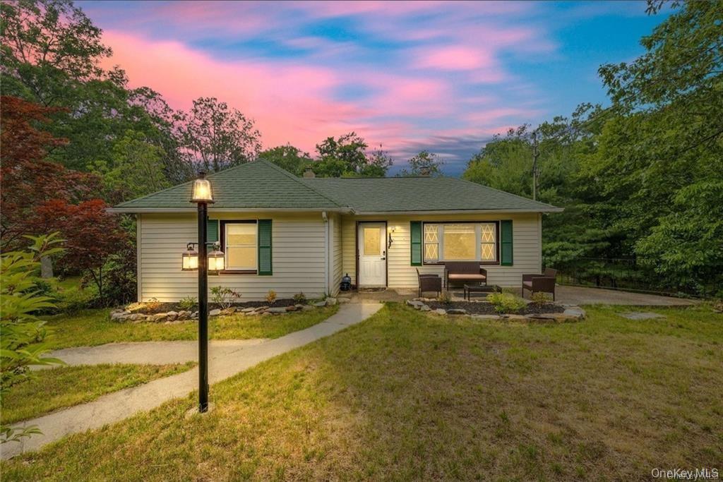 a view of a house with backyard and sitting area