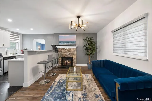 a living room with furniture a fireplace and a window