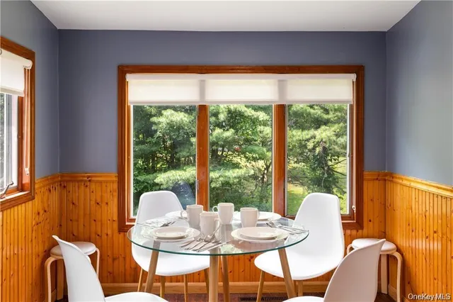 a dining room with furniture and window