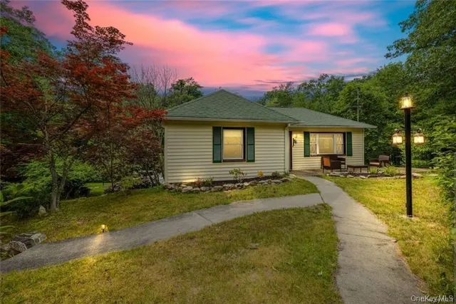 a view of a house with swimming pool and a yard
