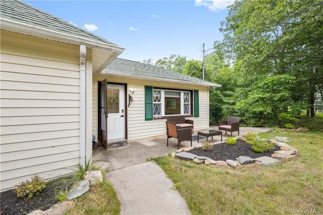 a view of a house with backyard and sitting area