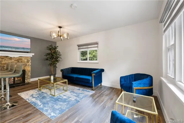 a living room with furniture and a chandelier