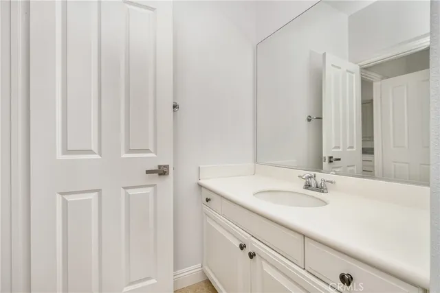 a bathroom with a sink toilet and mirror