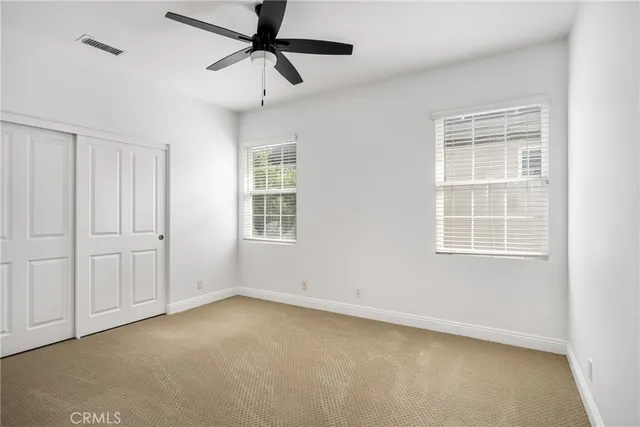 a view of staircase with white walls and a window