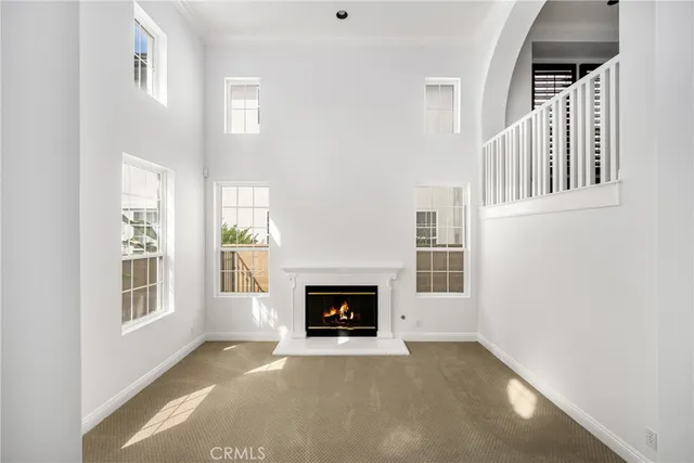 an empty room with windows and chandelier