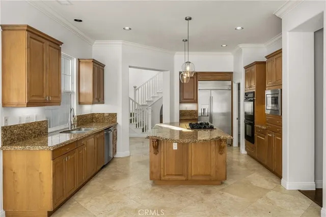 a front view of a house with garden and chairs