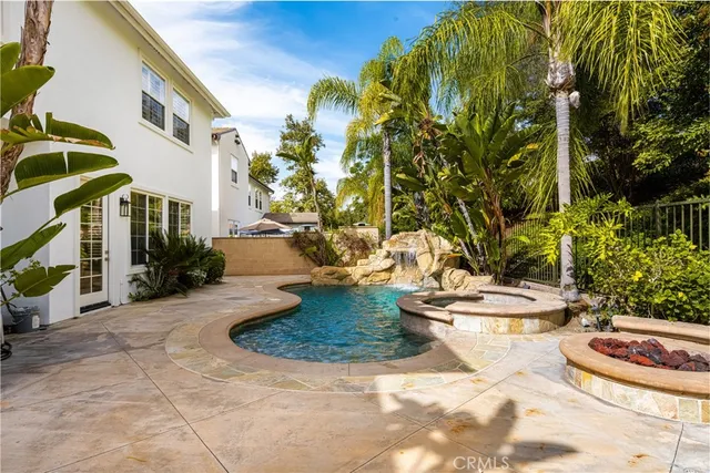 a view of a house with a yard and sitting area