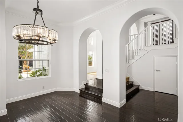 a view of entryway and hall with wooden floor