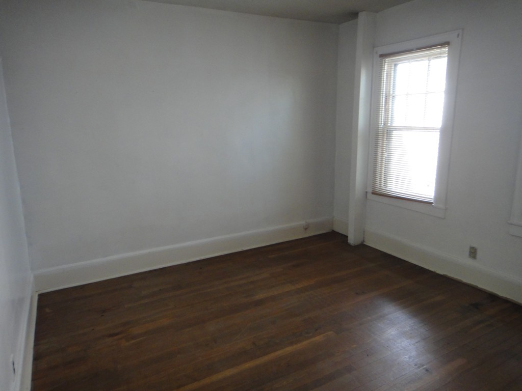 201 Marsden Street Springfield, MA 01109 - Photo 12 of 24 an empty room with wooden floor and windows