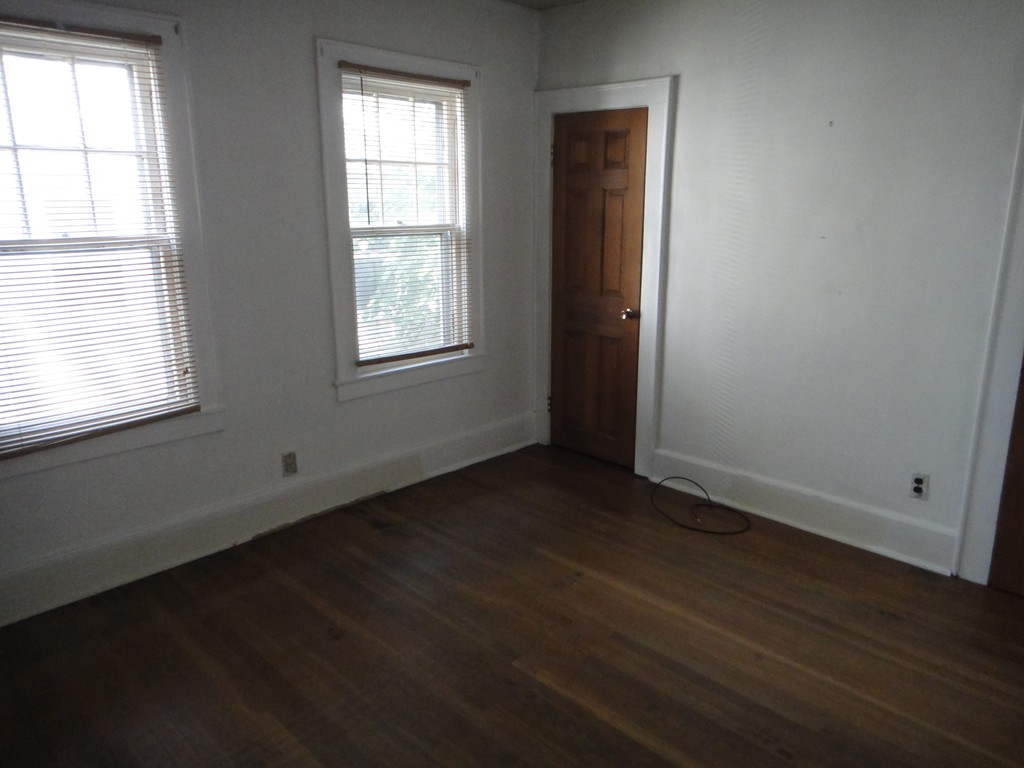 201 Marsden Street Springfield, MA 01109 - Photo 13 of 24 an empty room with wooden floor and windows