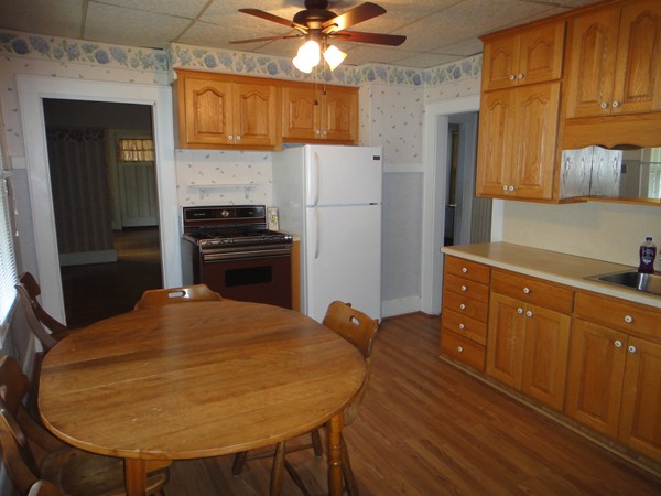 201 Marsden Street Springfield, MA 01109 - Photo 2 of 24 a kitchen with a table chairs refrigerator and cabinets