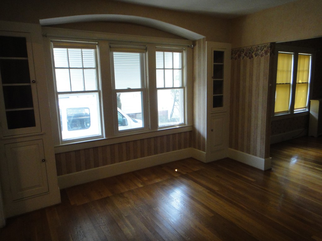 201 Marsden Street Springfield, MA 01109 - Photo 5 of 24 an empty room with wooden floor and windows