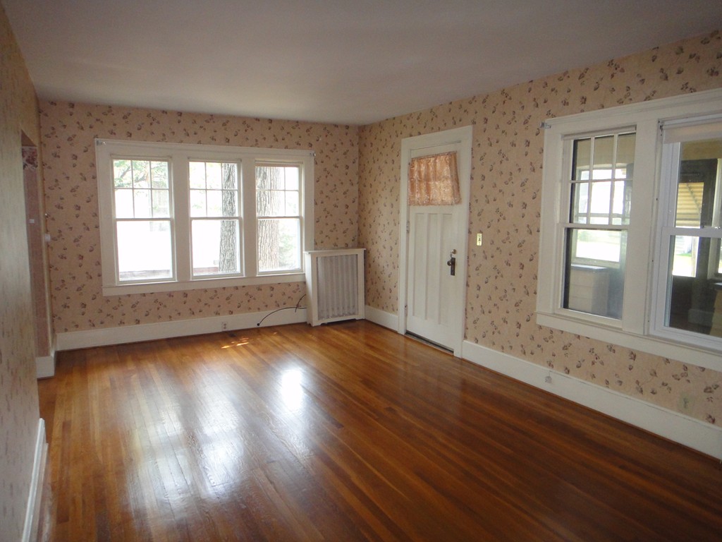 201 Marsden Street Springfield, MA 01109 - Photo 6 of 24 a view of an empty room with wooden floor and a window