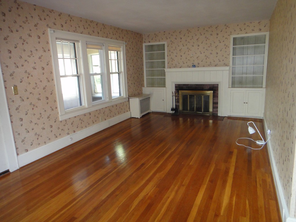 201 Marsden Street Springfield, MA 01109 - Photo 7 of 24 a view of empty room with wooden floor and fireplace