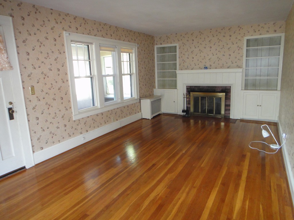 201 Marsden Street Springfield, MA 01109 - Photo 8 of 24 a view of empty room with wooden floor and fireplace