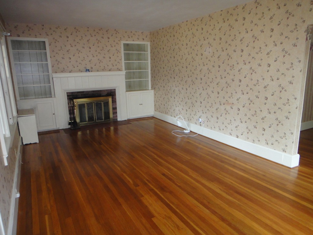 201 Marsden Street Springfield, MA 01109 - Photo 9 of 24 a view of empty room with wooden floor and fireplace