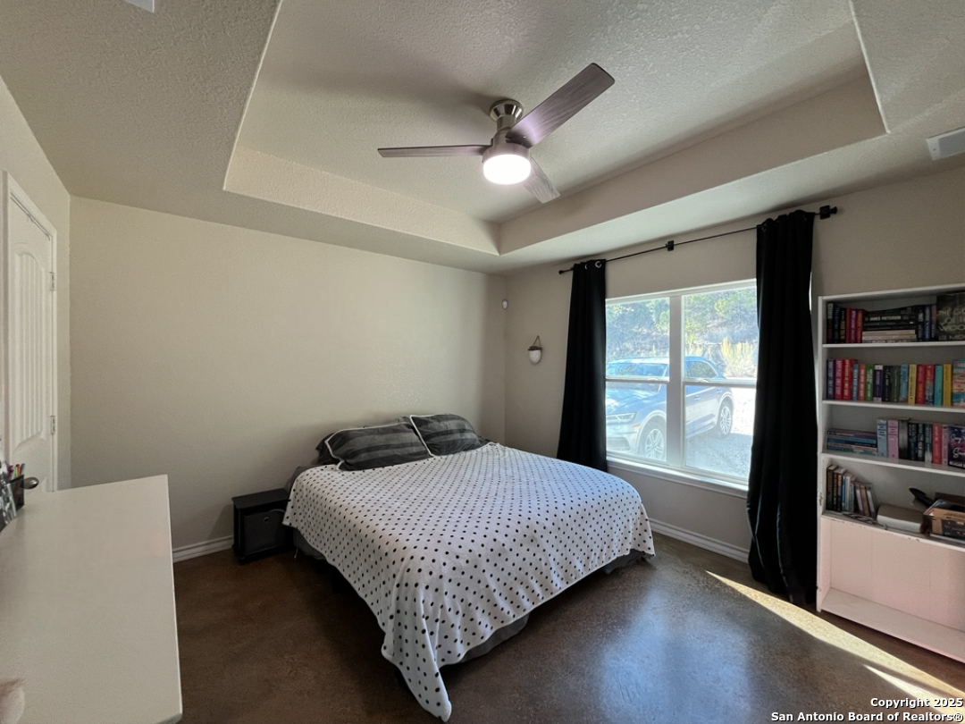 2708 Golf Drive Spring Branch, TX 78070 - Photo 12 of 31 a bedroom with a bed and a large window